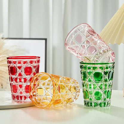 Set of colorful geometric heavy whiskey glass tumblers in red green and amber hues for dining room use
