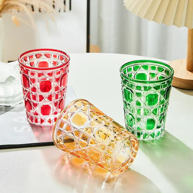 Three colorful faceted glass tumblers in red green and amber with geometric pattern heavy whiskey glass for dining room