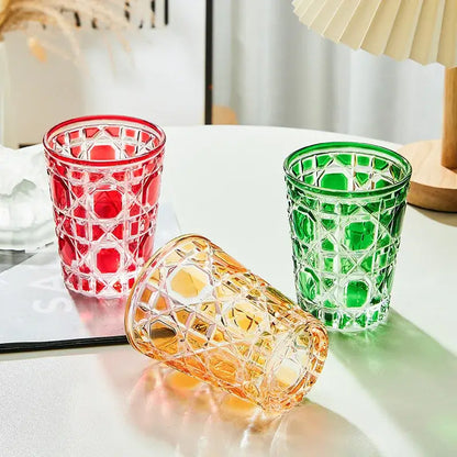 Three colorful faceted glass tumblers in red green and amber with geometric pattern heavy whiskey glass for dining room