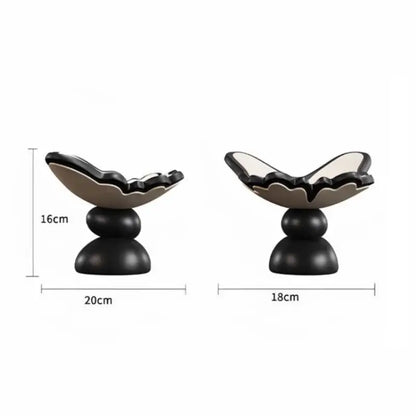 Black and white ceramic shell-shaped butterfly geometric resin tray on a two-tiered base for dining room storage
