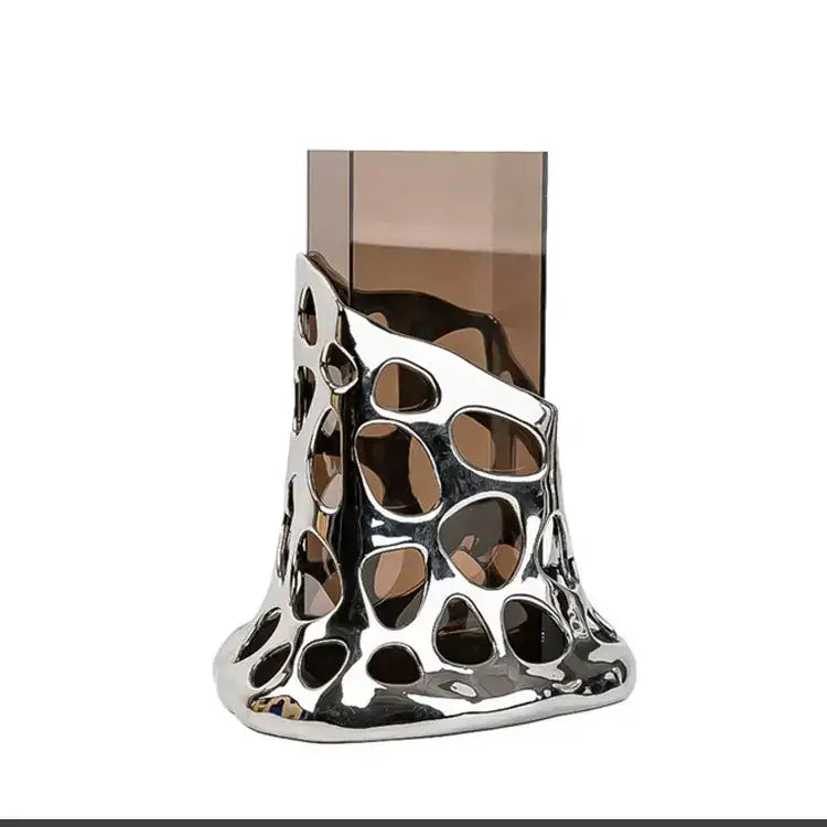 Silver metallic perfume holder with geometric acrylic glass cutouts holding amber glass bottle for decorbites glass vase use