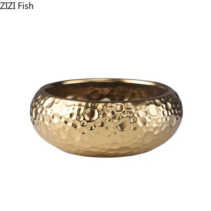 Gold-colored hammered metal bowl with textured bubble surface complementing minimalist ceramic vase decorbites decor
