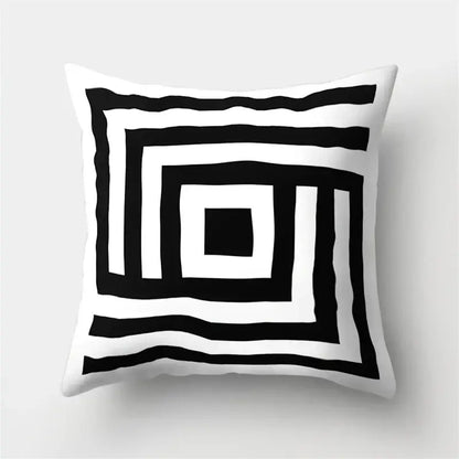 White throw pillow cover with bold black geometric star print featuring concentric wavy squares for home decor by decorbites