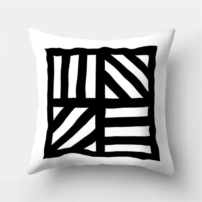 White throw pillow cover with bold black geometric star pattern for living room home decor by decorbites geometric star