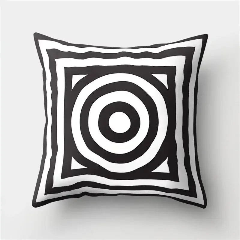 Black and white geometric star pillow cover with concentric circles and layered square borders for home decor by decorbites