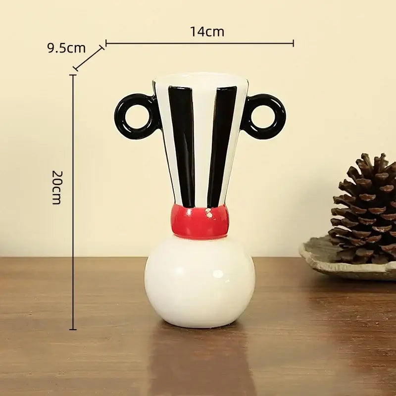 A white ceramic vase with black geometric stripes circular handles and a red band for decorbites geometric stripes decor