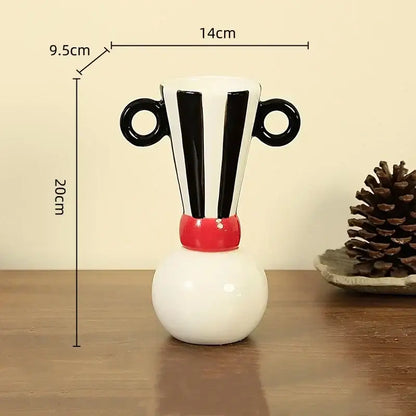 A white ceramic vase with black geometric stripes circular handles and a red band for decorbites geometric stripes decor