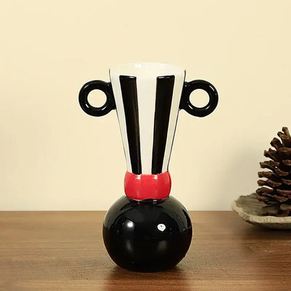 Black and white striped geometric stripes ceramic vase with red accent band and circular handles for living room decor