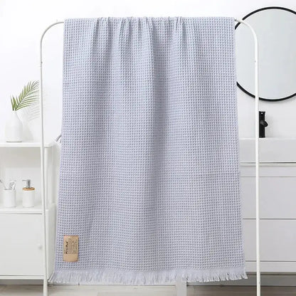 Light gray waffle-weave bath towel with soft textured surface and fringed edges for decorbites geometric tassel bath decor