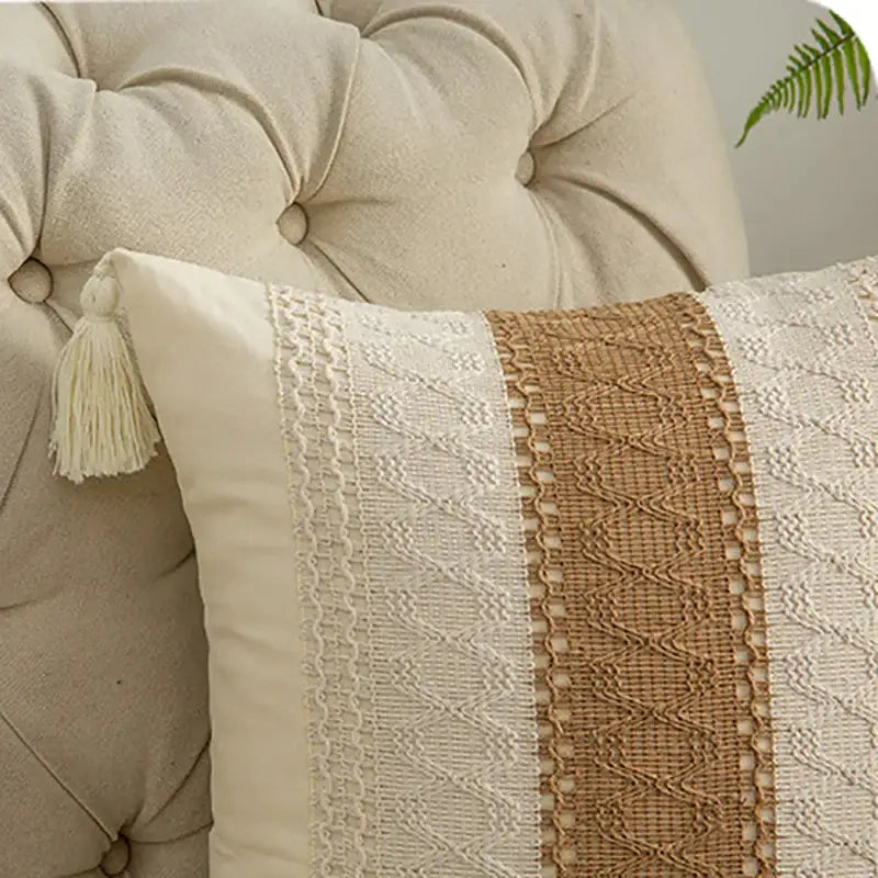 Cream-colored geometric tassel cushion cover with tan woven stripe, white lace, and matching tassel for decorbites decor