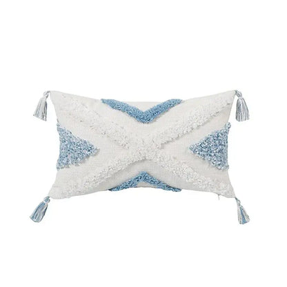 Rectangular white and light blue geometric tassel tufted pillow cover with woven pattern and corner tassels for living room
