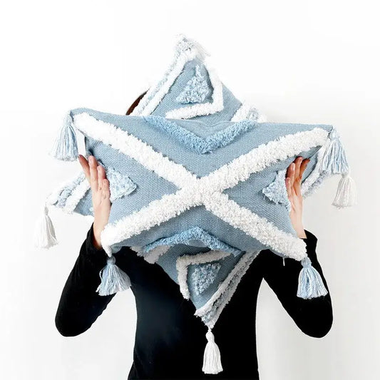 Light blue star-shaped pillow cover with white textured trim and geometric tassel tufted design for living room