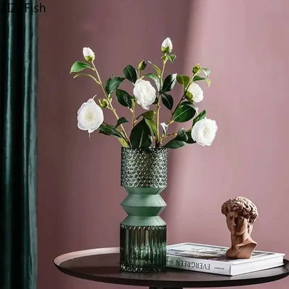 A tall geometric teal and green decorbites crystal clear glass vase with faceted upper and ribbed lower base for living room decor