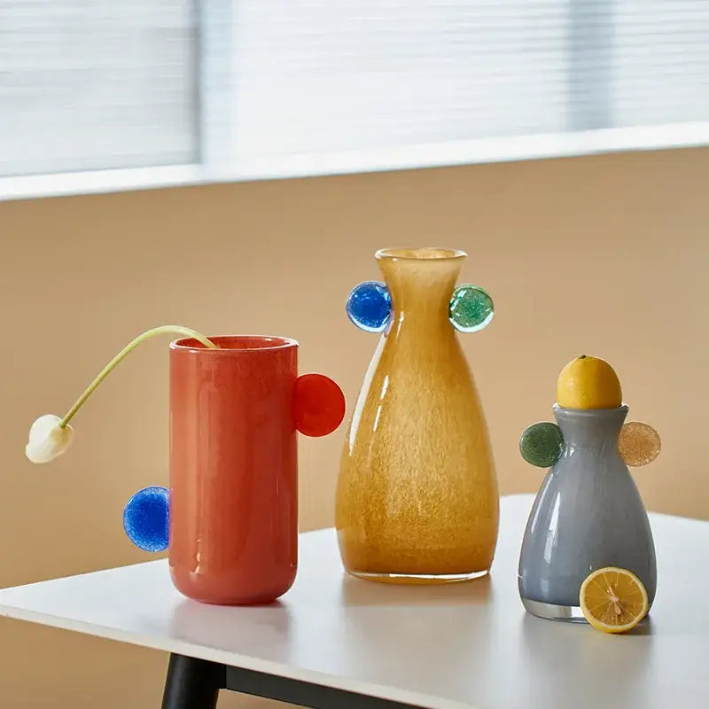 Three colorful glass vases with rounded appendages in red amber and gray for decorbites geometric glass decor accents