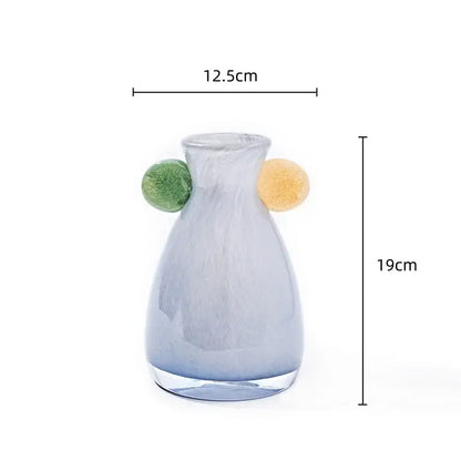 Translucent light blue decorbites geometric glass vase with rounded body and green and yellow accents for living room decor