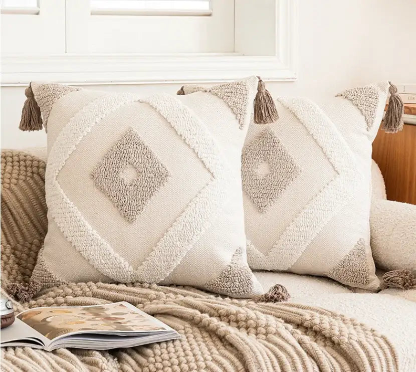Cream-colored cushion cover with decorbites geometric tufted beige pattern and tassel trim for living room decor