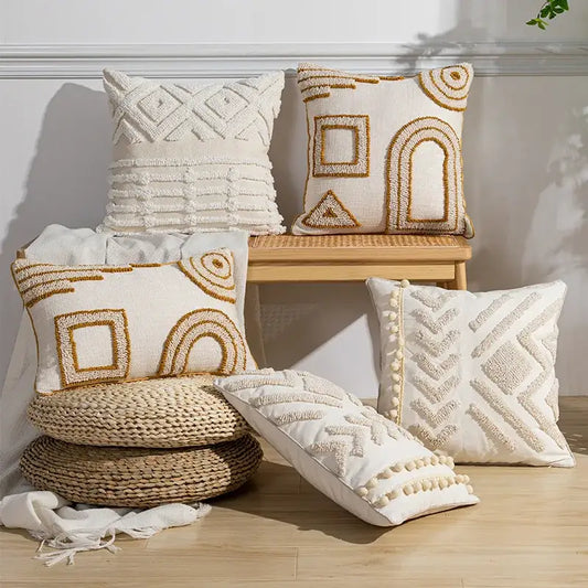 Cream-colored geometric tufted pillow covers with gold embroidery and pom-pom trim for living room decorbites decor