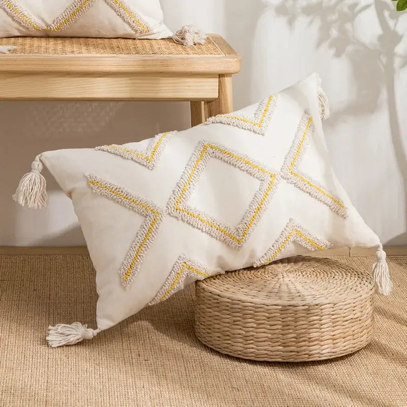 Cream-colored rectangular pillow cover with geometric tufted yellow and white fringe embroidery and tassels decorbites geometric tufted
