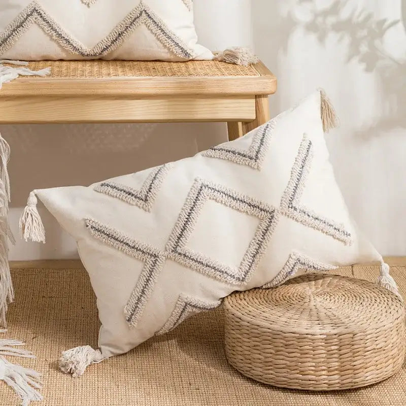 Cream-colored geometric tufted pillow covers with gray and white embroidery and tassels for decorbites living room decor