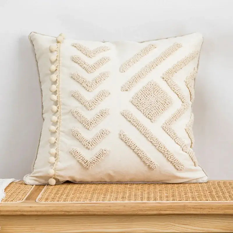 Cream-colored geometric tufted pillow cover with textured embroidery and pom-poms for living room decorbites decor