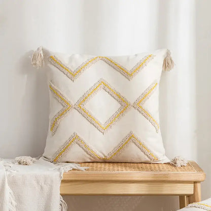 Cream-colored pillow cover with yellow and beige geometric tufted embroidery and tassels for living room decorbites decor