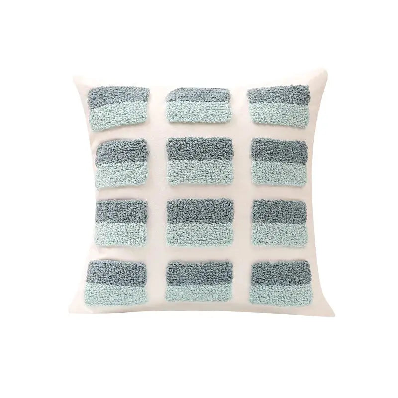 Off-white pillow cover with geometric tufted diamond pattern in teal, blue, and gray for living room decorbites decor