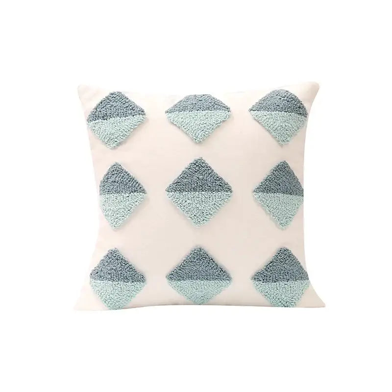 Cream-colored pillow cover with nine two-tone gray and mint green geometric tufted diamond appliqués for decorbites decor