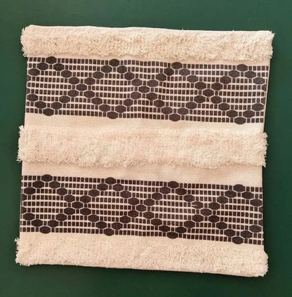 Beige towel with frayed edges and two dark brown geometric bands for decorbites geometric tufted cushion cover decor
