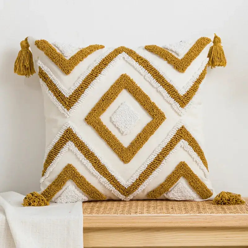 A cream-colored geometric tufted plush cushion cover with mustard yellow patterns and tassels for living room decorbites decor