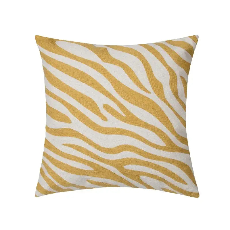 A square cushion cover with a bold mustard and white zebra print in textured fabric for decorbites geometric tufted plush decor