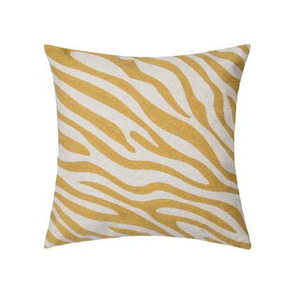 A square cushion cover with a bold mustard and white zebra print in textured fabric for decorbites geometric tufted plush decor