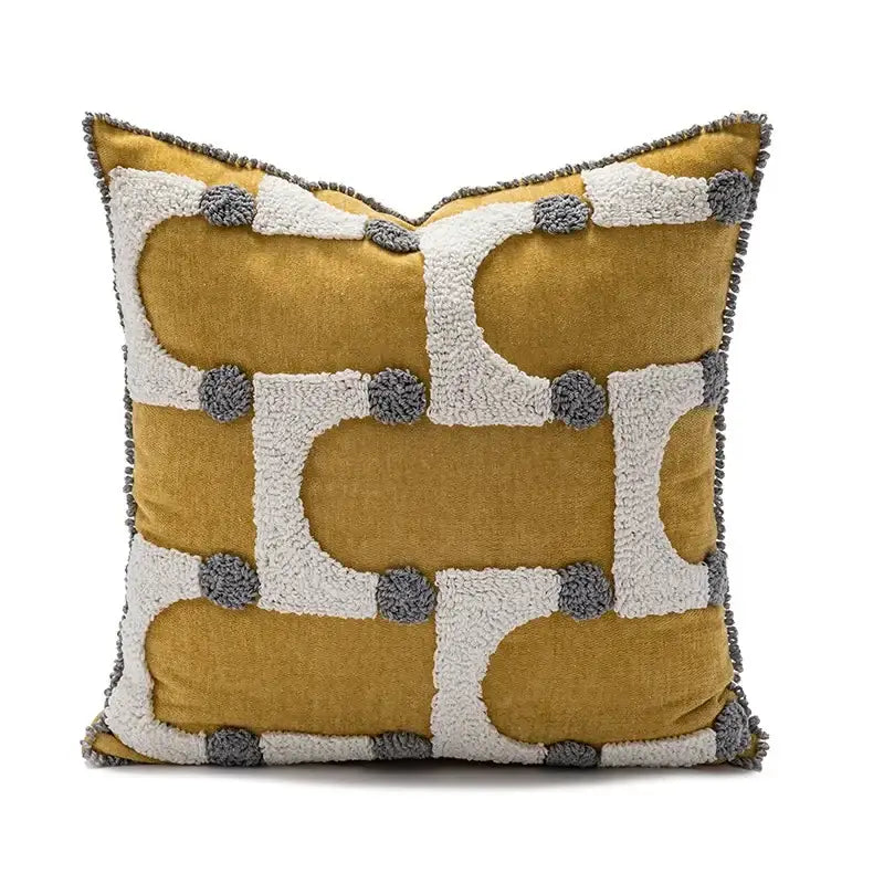Mustard yellow cushion cover with white and gray geometric tufted plush patterns and pom-pom accents decorbites geometric tufted