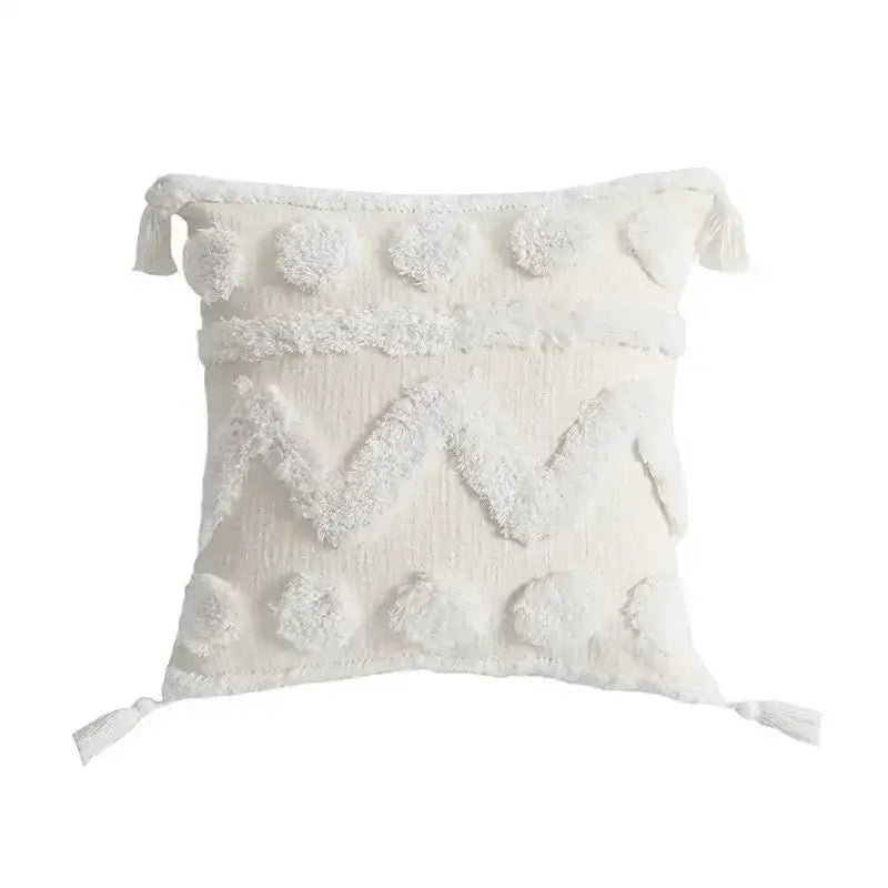 Cream-colored geometric tufted tassel cushion cover with textured fabric and fluffy pom-poms for living room decor
