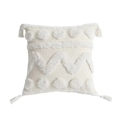 Cream-colored geometric tufted tassel cushion cover with textured fabric and fluffy pom-poms for living room decor