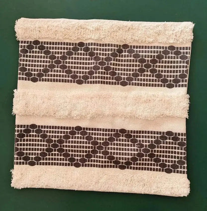 Beige geometric tufted tassel cushion cover with dark brown striped pattern and frayed edges for living room decor