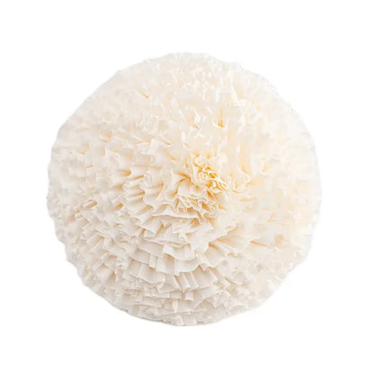 A round off-white paper pom-pom with layered ruffled edges complements decorbites geometric tufted tassel cushion cover