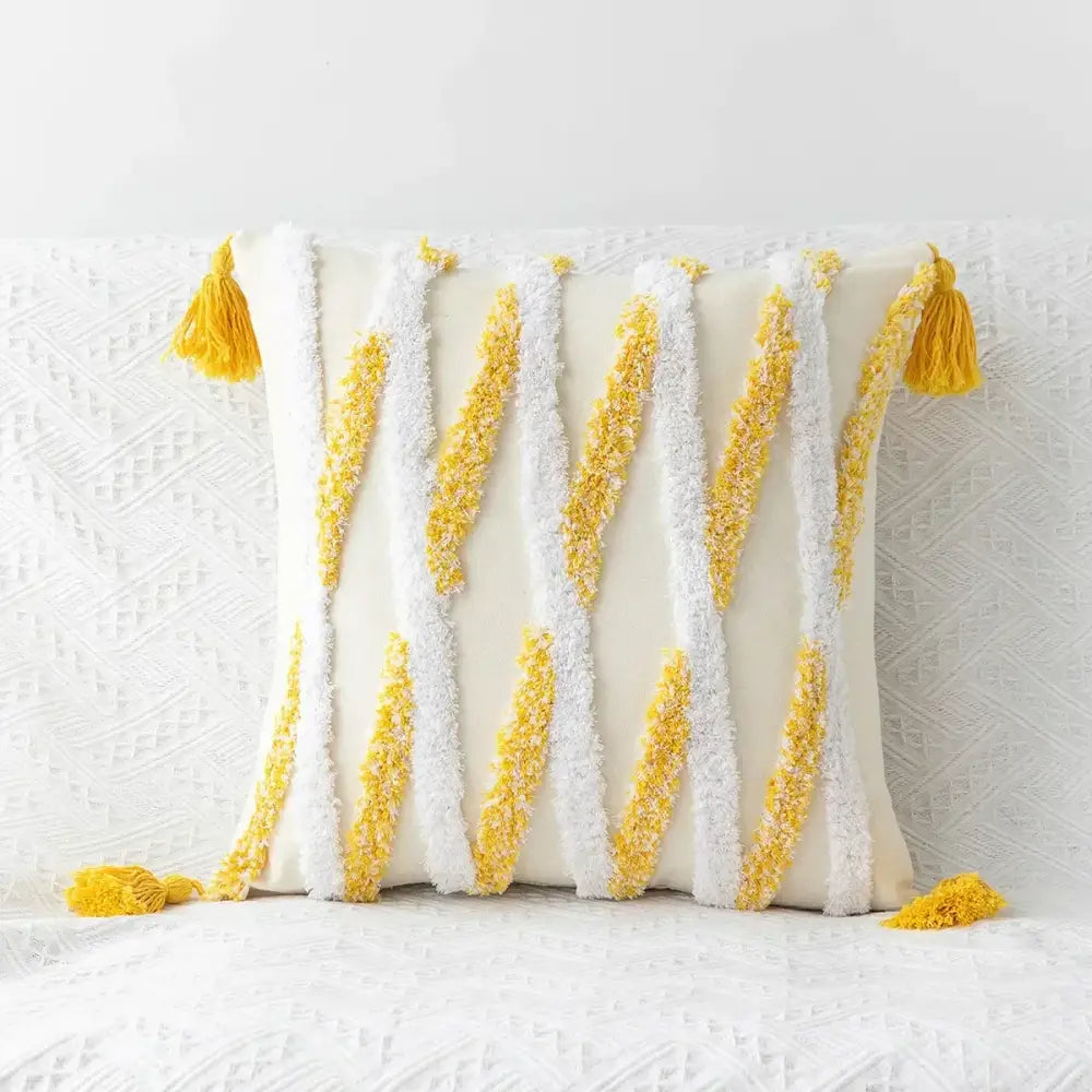 Cream-colored geometric tufted tassel cushion cover with bold yellow and white striped tassels for living room decor