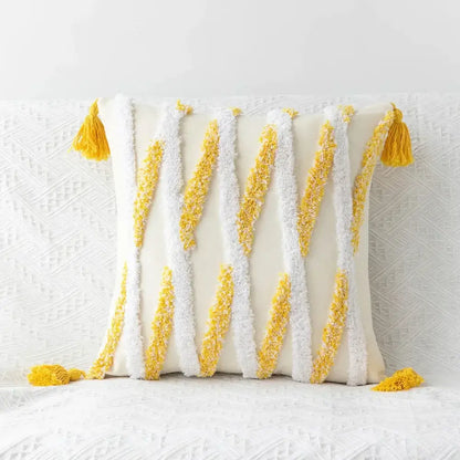 Cream-colored geometric tufted tassel cushion cover with bold yellow and white striped tassels for living room decor