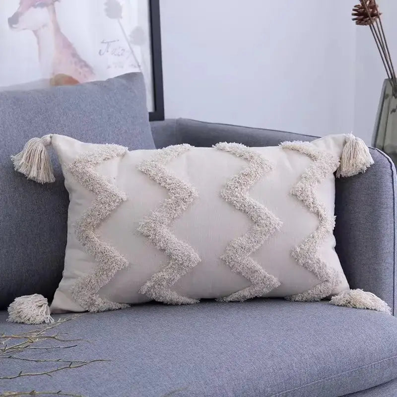 Cream-colored geometric tufted tassel cushion cover with zigzag fringe and tassels for beige and gray living room decorbites