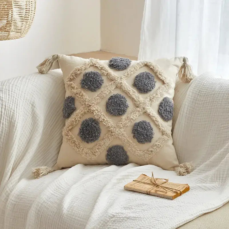 Beige cushion cover with gray pom-pom accents and tassels featuring decorbites geometric tufted tassel design for living room decor