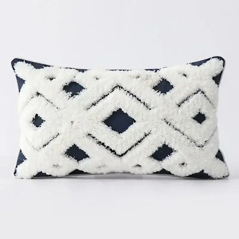 Rectangular cushion cover with bold black and white geometric tufted tassel pattern on dark navy background decorbites geometric tufted