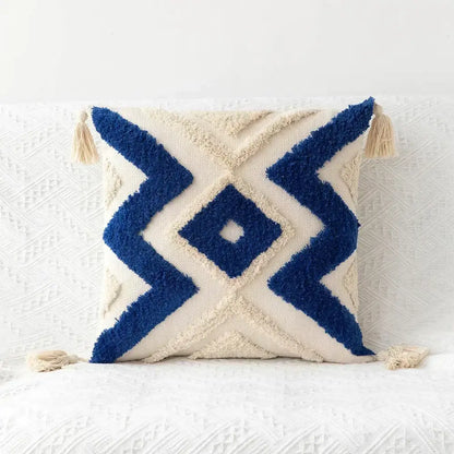 Cream-colored cushion cover with bold navy blue geometric tufted tassel patterns for beige and gray living room decorbites