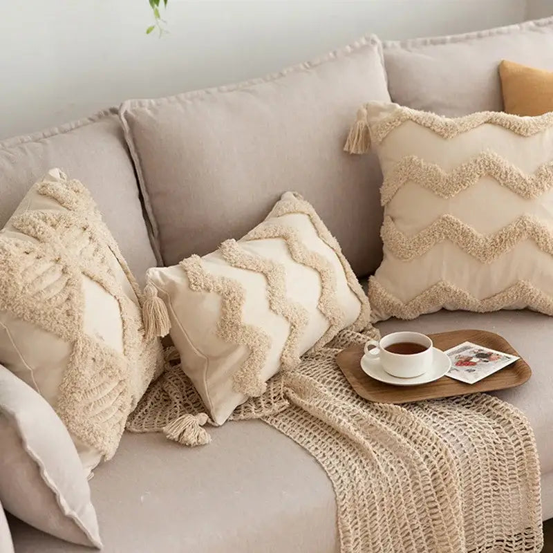 Cream-colored geometric tufted tassel pillowcases with textured fringed zigzag patterns in beige cotton linen decorbites style