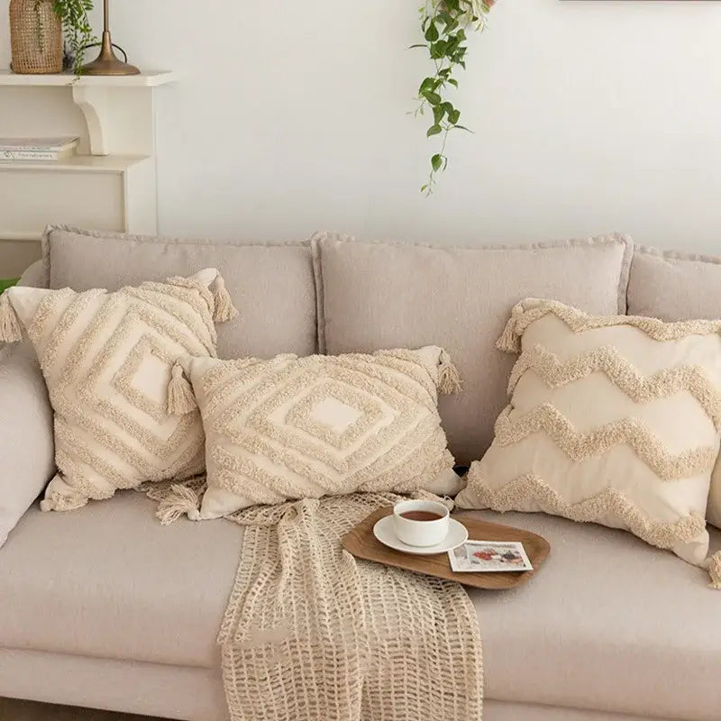 Cream-colored geometric tufted tassel pillowcases in beige cotton linen with textured patterns on a sofa decorbites decor