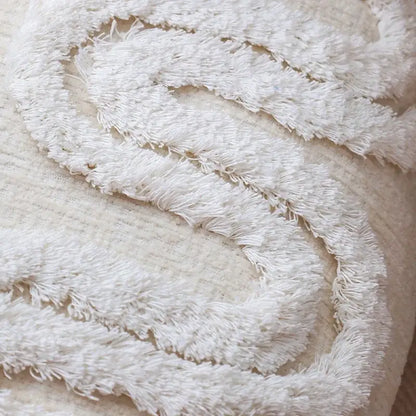 A plush off-white decorbites geometric waves tufted pillow cover with textured fabric and soft fringed edge for bedroom decor