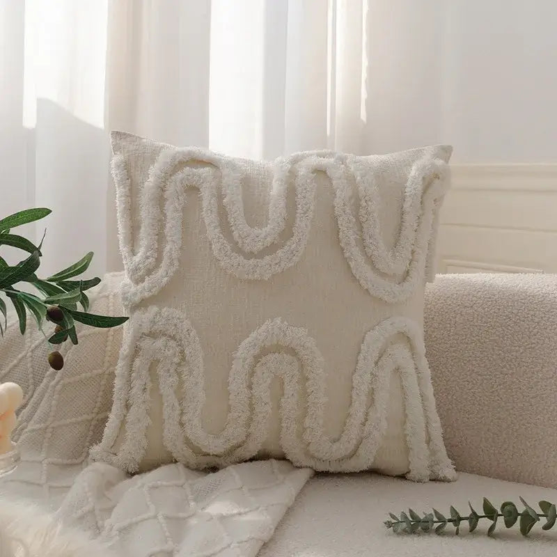 Cream-colored pillow cover with geometric waves tufted pattern and textured fringe in soft plush fabric for decorbites