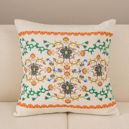 A square off-white pillow cover with embroidered floral patterns and scalloped orange borders from decorbites geometric waves tufted collection
