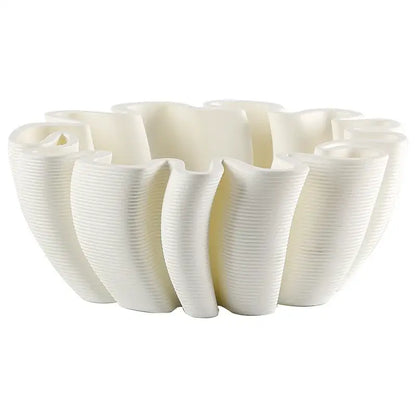 White ceramic fruit plate tray with sculpted petal design and vertical ribbed texture for kitchen storage