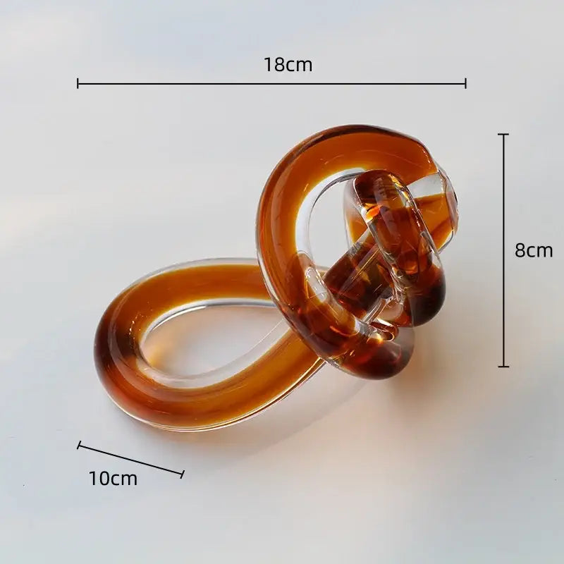 A translucent amber glass ring with a twisted twine knot design for home decor by decorbites geometric glass