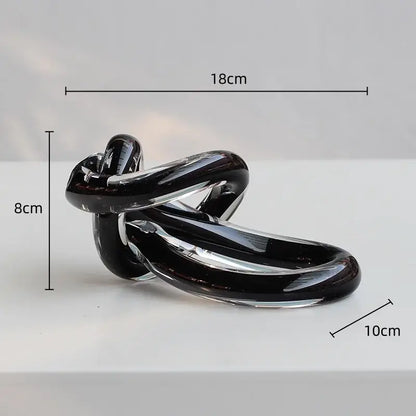 A sleek glossy black glass twine knot sculpture for home decor by decorbites geometric glass living room decor